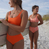 Reversible Hawaiian floral bikini top with adjustable straps, perfect for beach adventures.