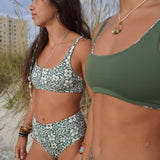 Reversible Hawaiian floral bikini top with adjustable straps, perfect for beach adventures.