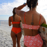 Reversible Hawaiian floral bikini top with adjustable straps, perfect for beach adventures.