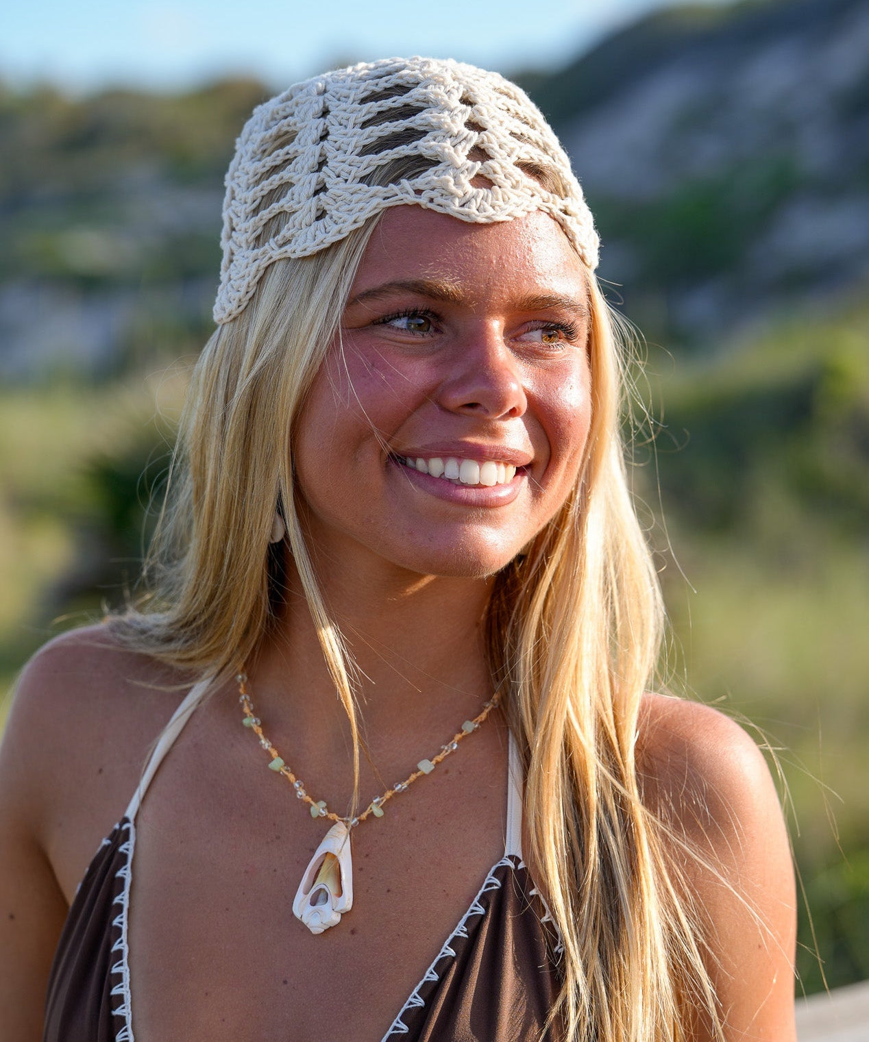 Woman wearing a crochet cap and bikini top outdoors
